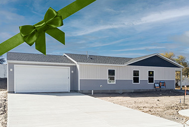 Blue sky with clouds and one-level home and two-car attached garage in rawlins wy with grey white and blue accents